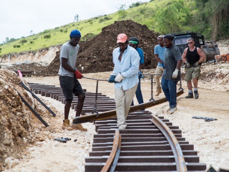 Track workers installing a length of rail. Photo by Sofie Warren.