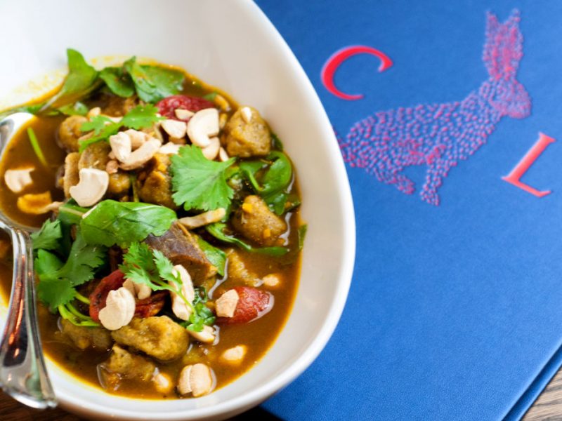 Compère Lapin's curried goat, sweet plantain gnocchi, roasted tomatoes, cashews, and cilantro. Photo courtesy StarChefs.