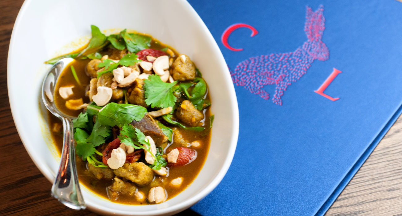Compère Lapin's curried goat, sweet plantain gnocchi, roasted tomatoes, cashews, and cilantro. Photo courtesy StarChefs.